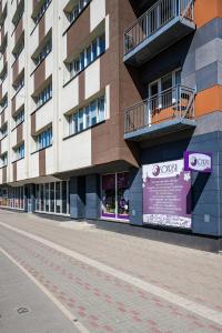 an empty street in front of a building at SUNSET urban apartment in Liepāja