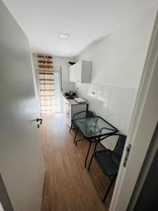 a kitchen with two chairs and a table in a room at Apartmani Neo in Sutomore