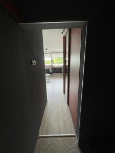 a hallway with a door leading into a room at City Center Apartment in Katowice