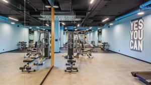 a gym with several rows of tread machines at Apartament Arena Gdynia in Gdynia