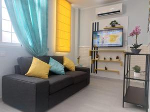 a living room with a couch and a television at La Palma in Tarajalejo