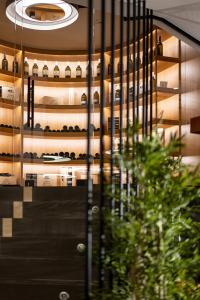 a glass door of a building with a wine rack at Amario Suites Hotel in Aigio