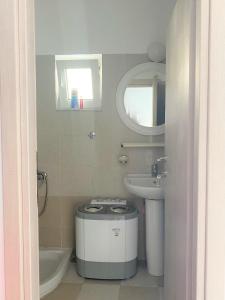 a small bathroom with a sink and a toilet at Alma Resorts Studio in Rhodes Town