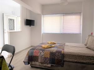 a bedroom with a bed and a tv on the wall at Alma Resorts Studio in Rhodes Town