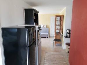 a kitchen with a black refrigerator in a room at Ferienwohnung mit Meerblick! in Sveti Vlas
