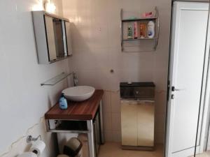 a small bathroom with a sink and a mirror at Ferienwohnung mit Meerblick! in Sveti Vlas +13 photos