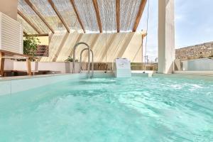 a hot tub in a house with a roof at 2 bedroom Villa with heated swimming pool-Spa whirlpool-BBQ! in Melidhónion
