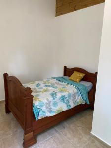 a bedroom with a bed with a quilt on it at Le Chalet des Rêves Ensoleillés in Saint-François