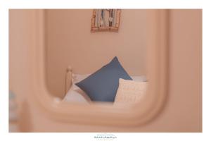 a blue pillow sitting on top of a bed at Ancóramare in Stintino