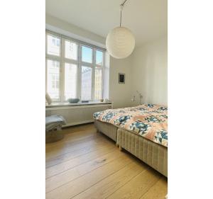 a bedroom with a bed and a large window at ApartmentInCopenhagen Apartment 1543 in Copenhagen