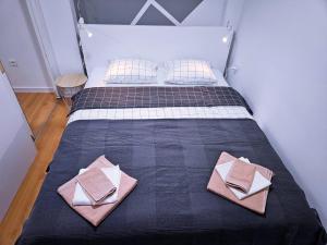 a bedroom with a bed with two pillows on it at Apartment D&L in Plitvička Jezera