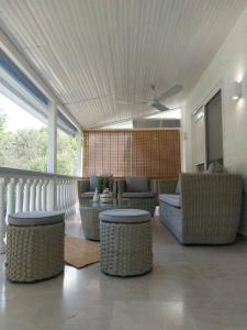 a living room with couches and chairs and a ceiling at Villa Angelika Nea Iraklitsa in Kavála