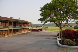 a car parked in a parking lot next to a building at Harvest Drive Family Inn - Renovated Rooms in Gordonville