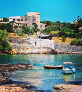 Álika的住宿－Kyparissos blue stonehouse，船停靠在水体中
