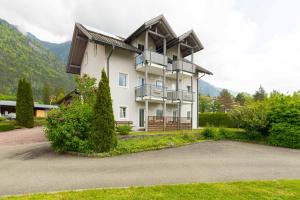 a large white building with a balcony and a driveway at Appartment Isabelle in Lake Pressegg