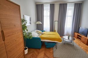 a bedroom with a bed with a yellow blanket at Renovated & Cozy - Close to Museumsquartier in Vienna