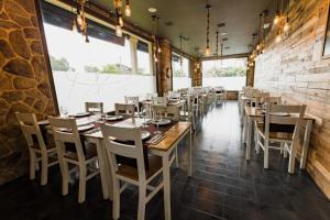 a dining room with wooden tables and chairs at O Lar de Pereiras in Meaño