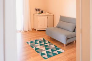 a living room with a chair and a rug at Ancóramare in Stintino