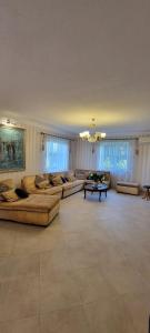 a large living room with couches and a table at Трушки34/1 in Trushki