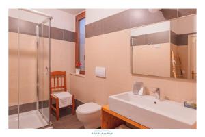a bathroom with a sink and a toilet and a shower at Ancóramare in Stintino
