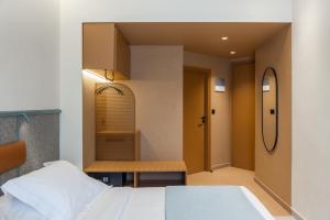 a bedroom with a bed and a bench in it at Evripides Hotel in Athens