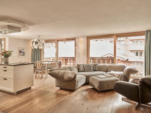 a living room with a couch and a table at Firefly Luxury Suites in Zermatt