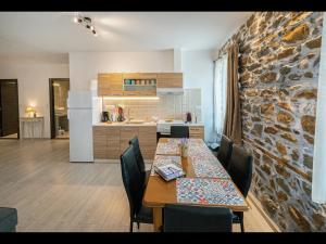 a kitchen and dining room with a table and chairs at DreamStone Residence in Skala Prinou