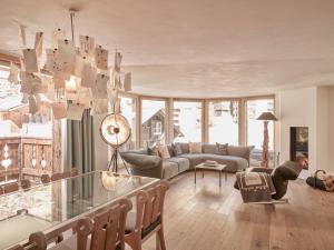 a living room with a couch and a table at Firefly Luxury Suites in Zermatt