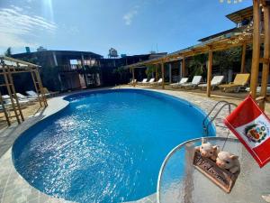 two teddy bears sitting on a table next to a swimming pool at Mancora y Sol in Máncora