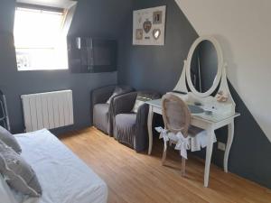 1 dormitorio con tocador y espejo en Cosy maison Honfleur 2 chambres parking jardin et jacuzzi, en La Rivière Saint Sauveur