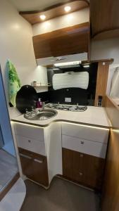 a kitchen with a sink and a stove at Camper in Sandnes