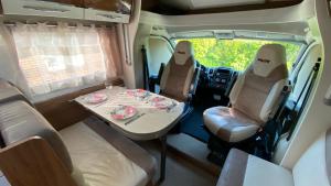 a dining table in the back of an rv at Camper in Sandnes