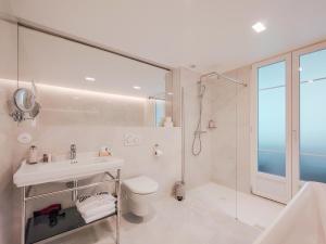 a bathroom with a sink and a toilet and a shower at Aparthotel AMMI Nice Lafayette in Nice