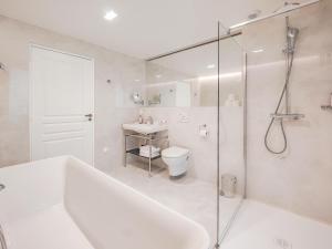 a bathroom with a tub and a toilet and a shower at Aparthotel AMMI Nice Lafayette in Nice