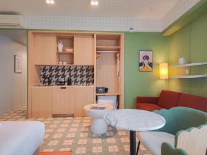 a room with a bed and a couch and a bathroom at Aparthotel AMMI Nice Lafayette in Nice