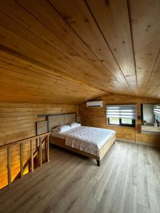 a bedroom with a bed in a wooden room at Cebel Tiny House&Bungalovs in Kemer