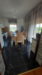 a kitchen and dining room with a table and chairs at Apartman Danny in Slunj