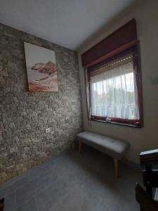 a room with a window and a bench in it at Apartman Danny in Slunj