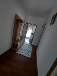 a stairway with a mirror in a room at Apartman Danny in Slunj