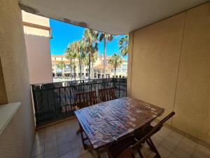 a balcony with a table and chairs on a balcony at Appartement 2P cabine, 100m plage, terrasse, parking - Argelès-sur-Mer - FR-1-388-94 in Argelès-sur-Mer +3 photos