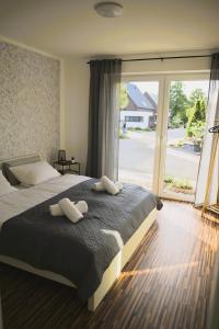a bedroom with a large bed and a large window at Ferienwohnung an der Steinfurter Aa in Steinfurt