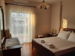 um quarto com uma cama e uma janela com toalhas em Arbutus house em Preveza