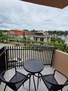 a patio with two chairs and a table on a balcony at New House Kobuleti 2 in K'obulet'i