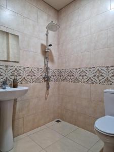 uma casa de banho com um chuveiro, um WC e um lavatório. em New House Kobuleti 2 em Kobuleti