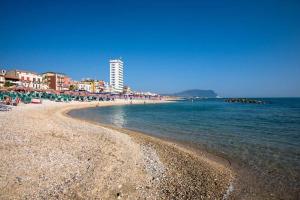 a beach with chairs and umbrellas and the ocean at mentamarina in Porto Recanati