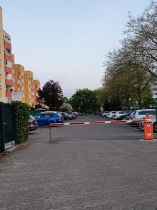 a parking lot with cars parked on a street at Maria Apartment in Wolfsburg