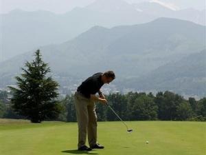 a man is playing golf on a field at Superbe appartement 6 pièces, 12 pers - Terrasse, garage, WIFI - FR-1-404-109 in La Mongie