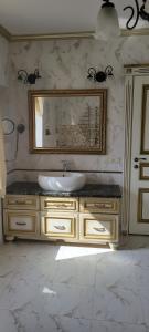 a bathroom with a sink and a mirror at Трушки34/1 in Trushki