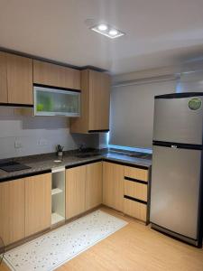 an empty kitchen with a refrigerator and wooden cabinets at Terrazas RV Adults Only No se cobran los impuestos in Posadas