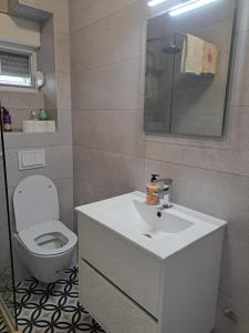 a bathroom with a white sink and a toilet at Ana in Neum
